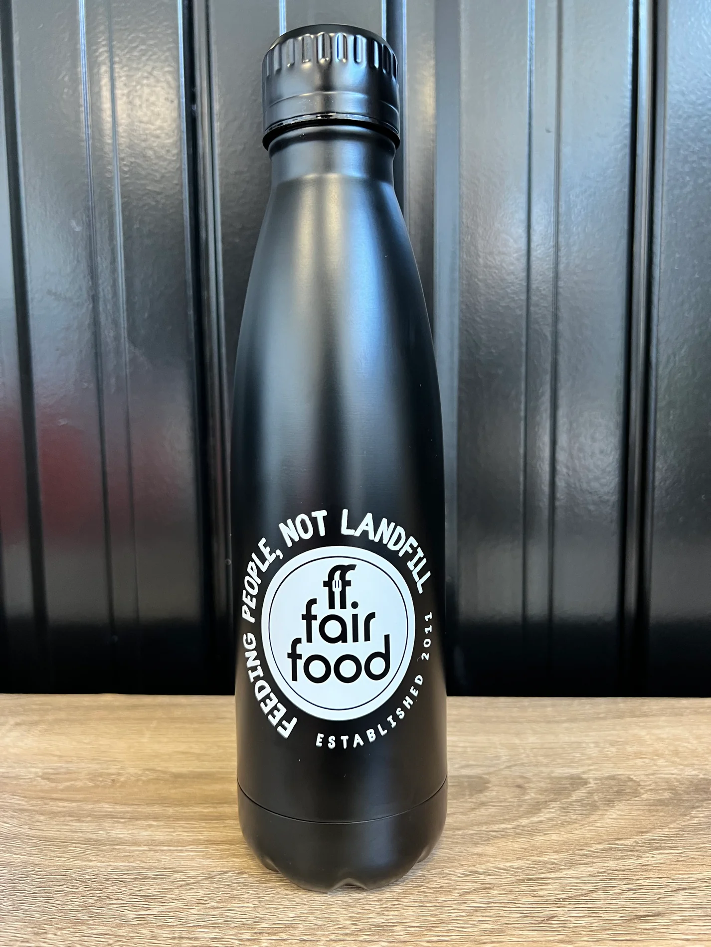 black water bottle with white Fair Food logo